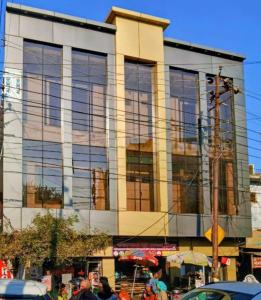 a large building with glass windows on a city street at Hotel Devi Residency Vrindavan - Near Premanand ji Maharaj And Prem Mandir, Banke Bihari ji in Jāmb