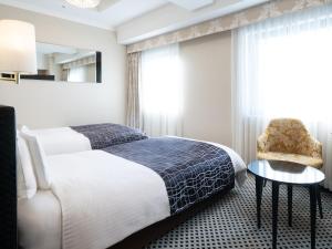 a hotel room with a bed and a chair at APA Hotel Ikebukuro Eki Kitaguchi in Tokyo