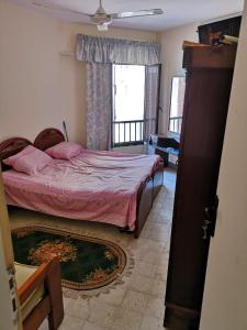 a bedroom with a bed and a window at Apartment in ALEX - AGMI in Alexandria