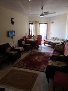 a living room with a couch and a table and chairs at Apartment in ALEX - AGMI in Alexandria
