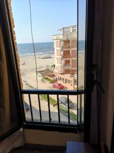 a view of the beach from a room with a window at Apartment in ALEX - AGMI in Alexandria