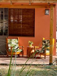 two chairs sitting on the porch of a house at Cabañas Rincon del Champa in San Javier