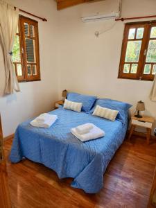 En eller flere senge i et værelse på Cabañas Rincon del Champa