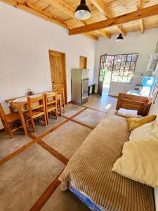 a large living room with a table and a kitchen at Cabañas Rincon del Champa in San Javier