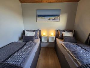 En eller flere senge i et værelse på Ferienhaus Küstenzauber Simonsberg Nordsee Meer Husum + 14 billeder