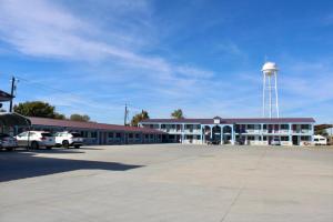 a school building with a water tower in the background at Kermit Inn in Kermit