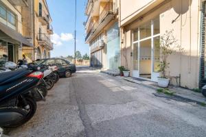 a row of motorcycles parked in a parking lot next to buildings at Verdea Suite in Ágios Rókkos