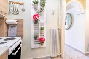 a kitchen with a door with potted plants at Verdea Suite in Ágios Rókkos +17 photos