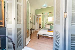a bedroom with a bed in a room with green walls at Verdea Suite in Ágios Rókkos