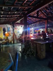 a room with a table and a room with lights at Pousada Solstício De Verão in Trindade +147 photos