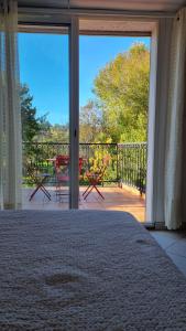 a bedroom with a large sliding glass door with a patio at L'appartement d'Ananda in Villefranche-de-Rouergue +9 photos