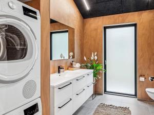 a bathroom with a washing machine and a sink at 5 star holiday home in Skals in Skals