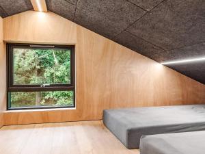 a bedroom with a bed and a window at 5 star holiday home in Skals in Skals