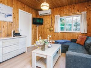 a living room with a couch and a table at 4 person holiday home in Ansager in Ansager