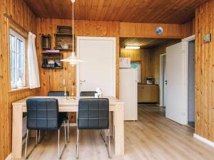 a kitchen and dining room with a table and chairs at 4 person holiday home in Ansager in Ansager