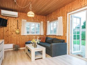 a living room with a couch and a table at 4 person holiday home in Ansager in Ansager +29 photos