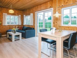 a kitchen and living room with a table and chairs at 4 person holiday home in Ansager in Ansager
