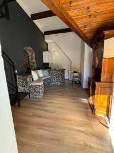 a living room with a couch and a stone wall at Gesuiti Home - Lumina Collection in Catania