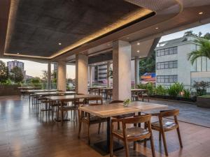 a row of tables and chairs in a restaurant at Mercure Jayapura in Jayapura