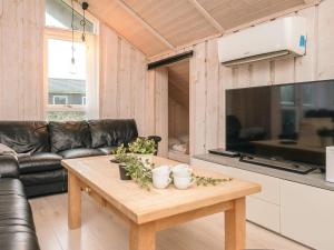 a living room with a table and a couch at 5 star holiday home in Ansager in Ansager