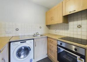 a kitchen with a washing machine and a sink at holiday in Waterford