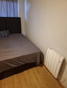 a small bedroom with a bed and a radiator at holiday in Waterford