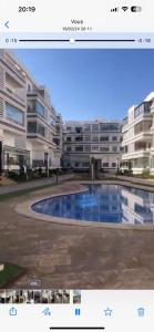 a view of a apartment building with a swimming pool at Résidences Mansbay Jasmin in Mansouria
