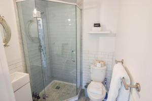 a bathroom with a toilet and a glass shower at East End Condo w Beach Access in Provincetown +17 photos