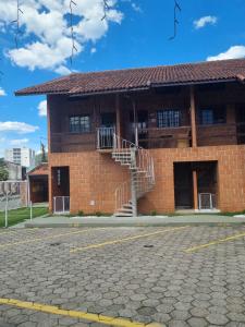 a brick building with a staircase in front of it at Flat I - 50 Metros da Praia in Caraguatatuba