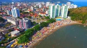 an aerial view of a city with a beach and buildings at Flat I - 50 Metros da Praia in Caraguatatuba +14 photos