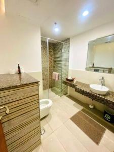 a bathroom with a toilet and a sink and a shower at GoldCrest Mall Luxury Apartments with Balcony In DHA Lahore in Lahore +28 photos