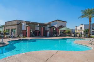 a large swimming pool in front of a building at Westgate & Stadium with BalconyPoolGymParkingWD in Glendale +38 photos