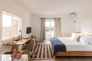 a bedroom with a bed and a desk and a deskablish at Outsite Vilamoura - Work, Connect, Explore in Quarteira