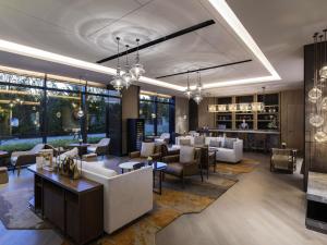 a lobby of a hotel with couches and tables at Grand Mercure Shanghai Lingang in Shanghai