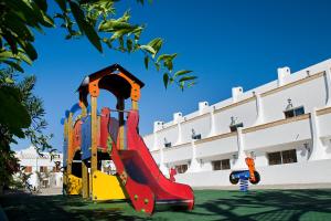 a playground with a slide in front of a building at Apartamentos Pirámides in Playa de las Americas