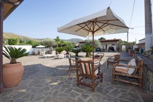 a patio with a table and chairs and an umbrella at B&B Fasolino in Castellabate