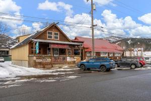 a building with two cars parked in front of it at SilverStrike Condos Family Friendly Walkable Location Unit 2 in Kellogg