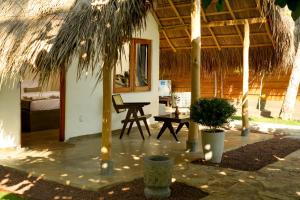 a room with a tent with a table and a bed at Sea View Clay House in Hiriketiya