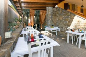 eine Reihe von weißen Tischen und Stühlen auf einer Terrasse in der Unterkunft B&B Fasolino in Castellabate