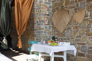 a table with fruit on it next to a brick wall at B&B Fasolino in Castellabate +29 photos