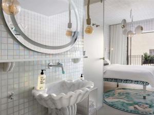 a bathroom with a bath tub in a room at 25hours Hotel Florence Piazza San Paolino in Florence +80 photos