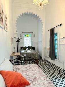 a room with two beds and a window at Riad Nostalgie of Tetouan in Tétouan