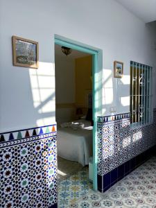 a bathroom with a mirror and a bed in a room at Riad Nostalgie of Tetouan in Tétouan +52 photos