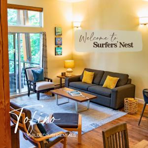 a living room with a couch and a table at Surfers' Nest - Waterfront home in Ucluelet in Ucluelet