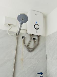 una ducha en un rincón de una habitación con un tanque de agua en ARC Towers Condominium, en Cebú