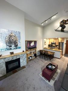 a living room with a fireplace and a television at XL Luxury Penthouse Ski-in Ski-out The Aspens in Whistler