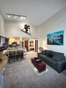 a living room with a person on skis in the air at XL Luxury Penthouse Ski-in Ski-out The Aspens in Whistler