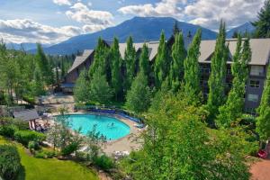 an aerial view of a resort with a swimming pool and trees at XL Luxury Penthouse Ski-in Ski-out The Aspens in Whistler