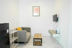 a living room with a couch and a coffee table at Casal Apartment by REJA Essentials in Nusa Dua