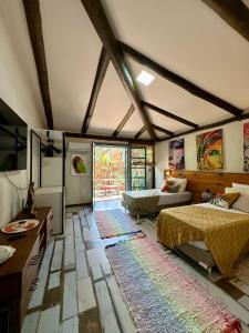 a large room with two beds and a table at Refúgio Serra das Águas in Araras Petropolis +24 photos